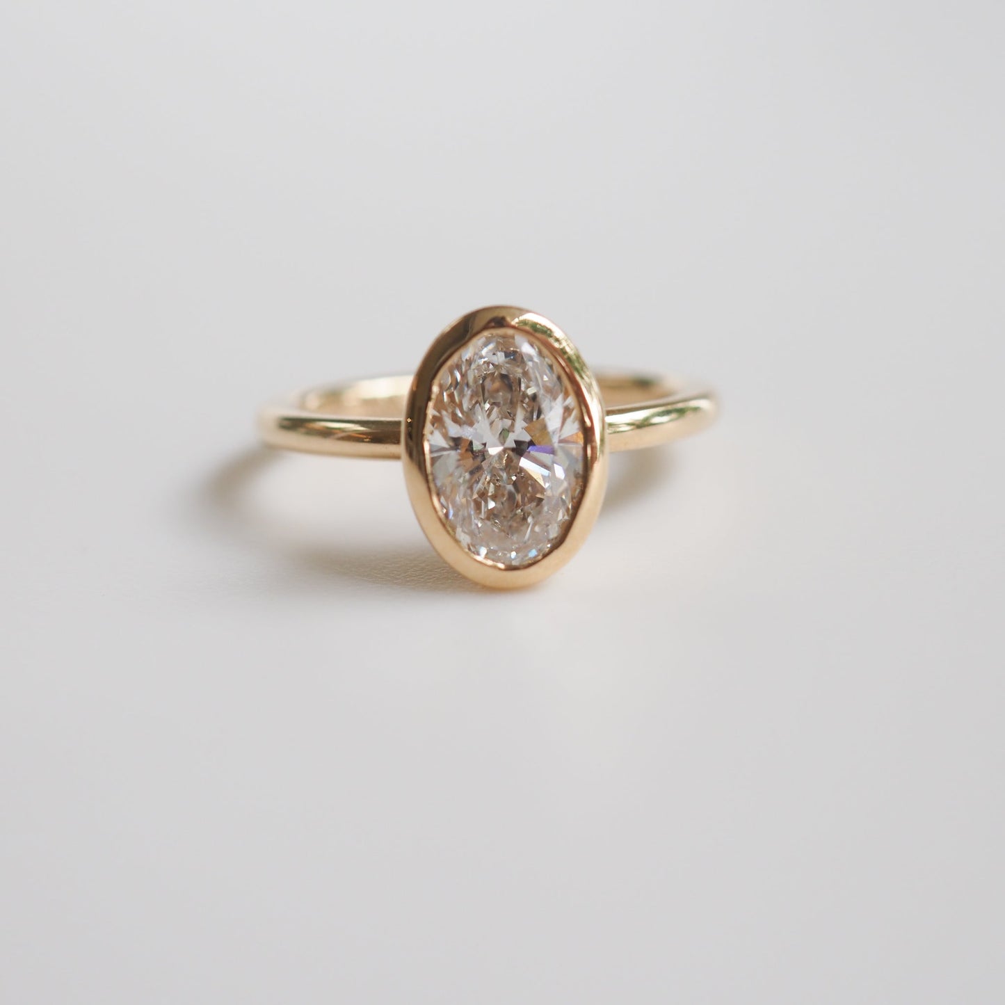 1.50 CT Oval Lab Grown Diamond Bezel Set Engagement Ring in Yellow Gold 6