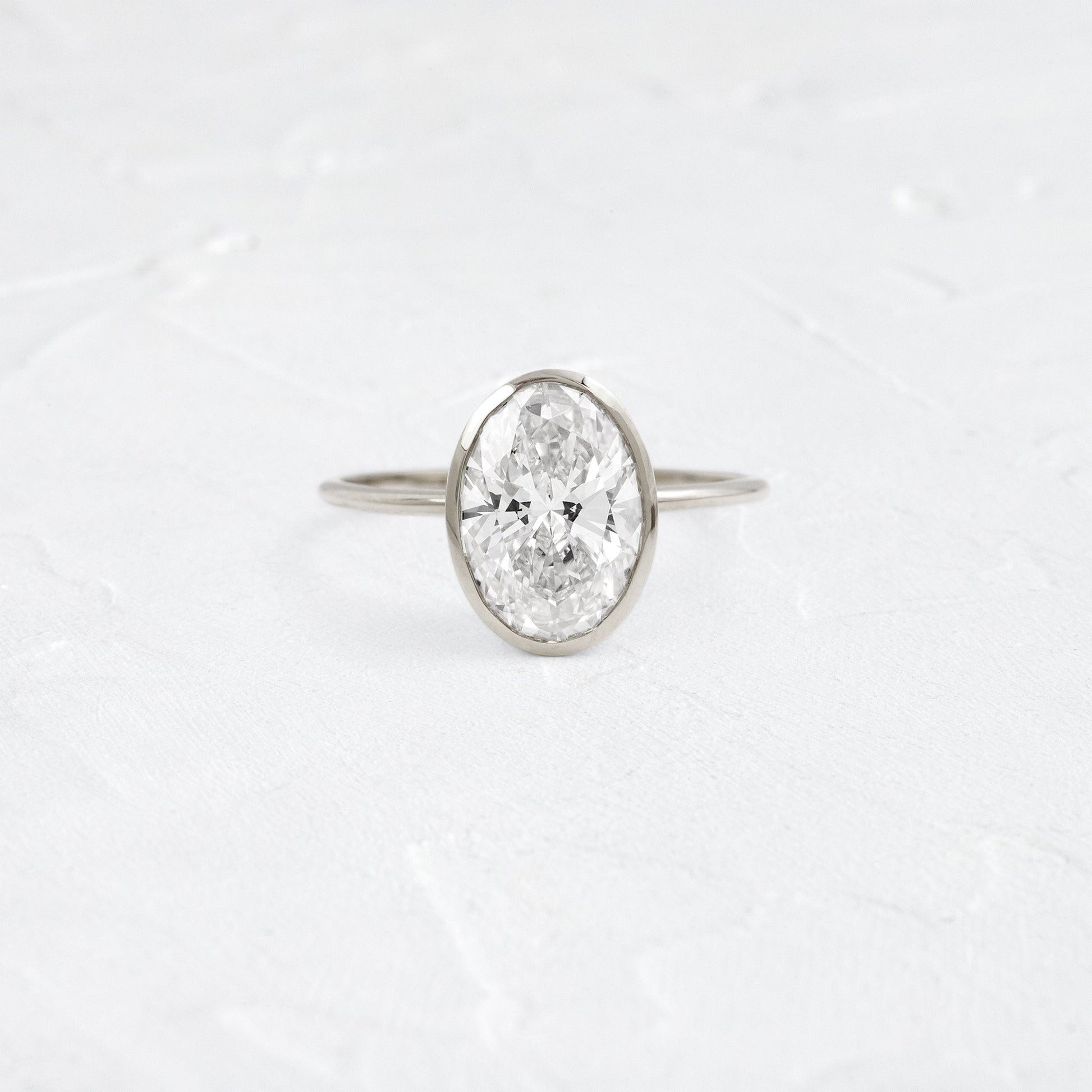 Bezel with Hidden Stones-Oval Lab Grown Diamond Engagement Ring