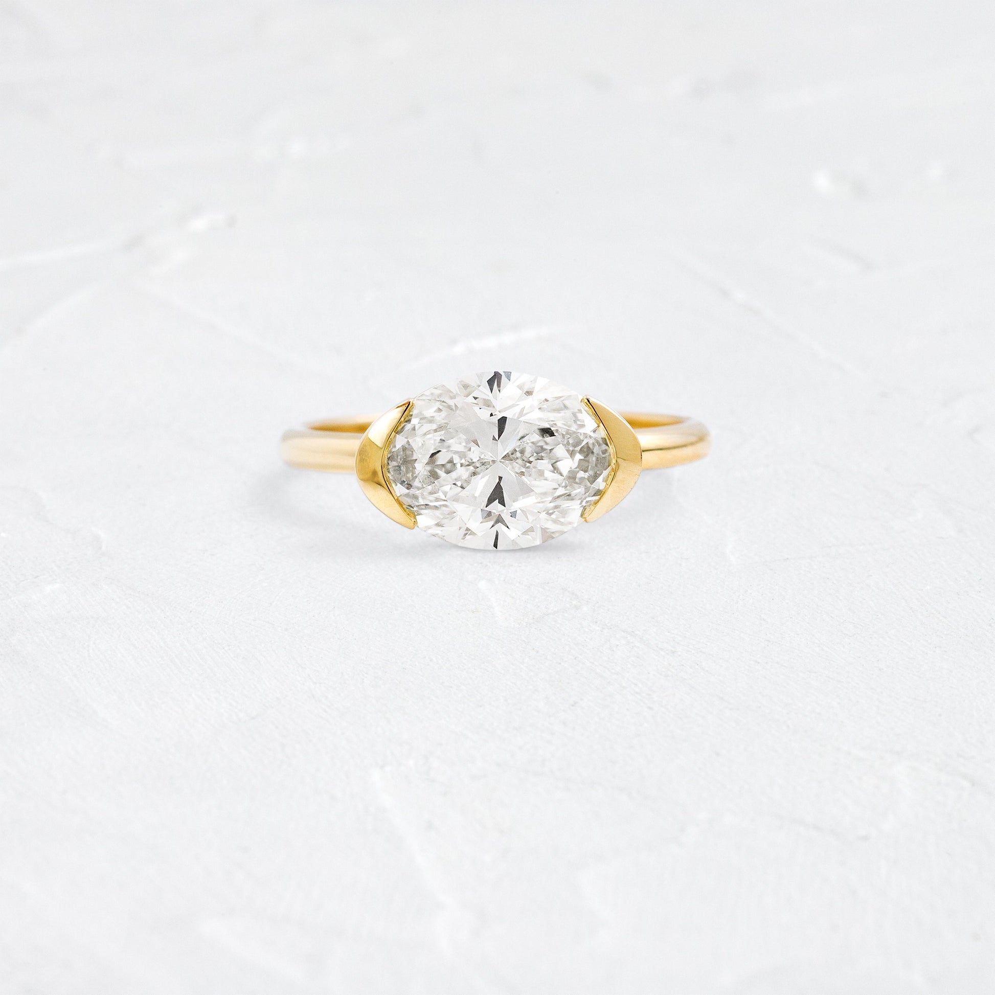 East West Solitaire Half Bezel-Oval Lab Grown Diamond Engagement Ring