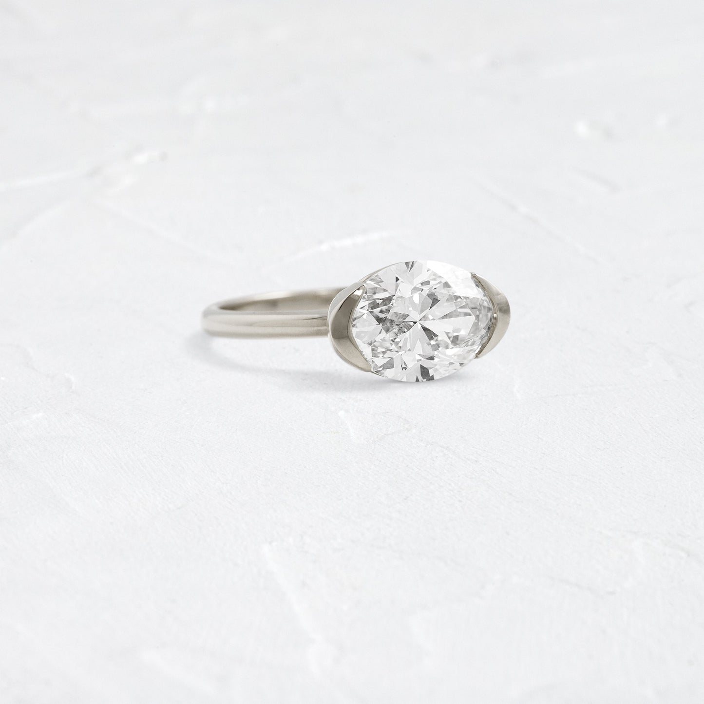 East West Solitaire Half Bezel-Oval Lab Grown Diamond Engagement Ring