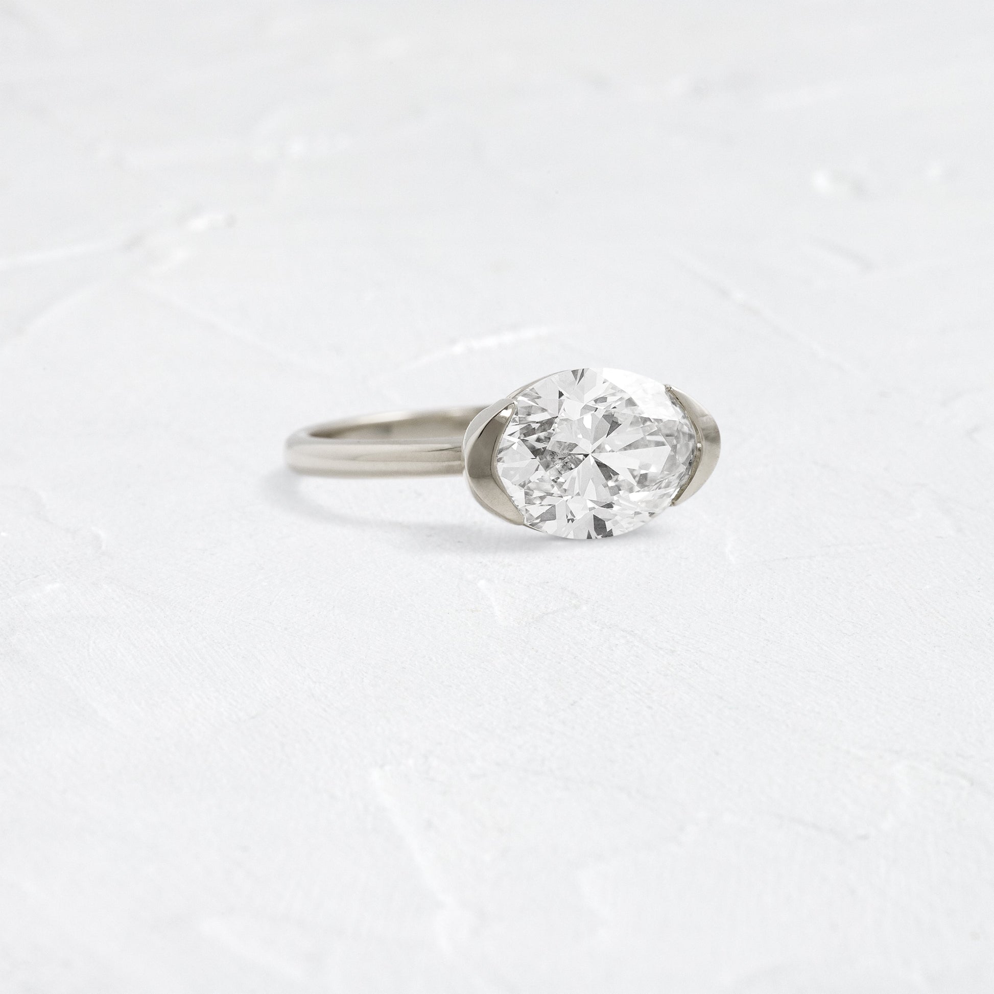 East West Solitaire Half Bezel-Oval Lab Grown Diamond Engagement Ring