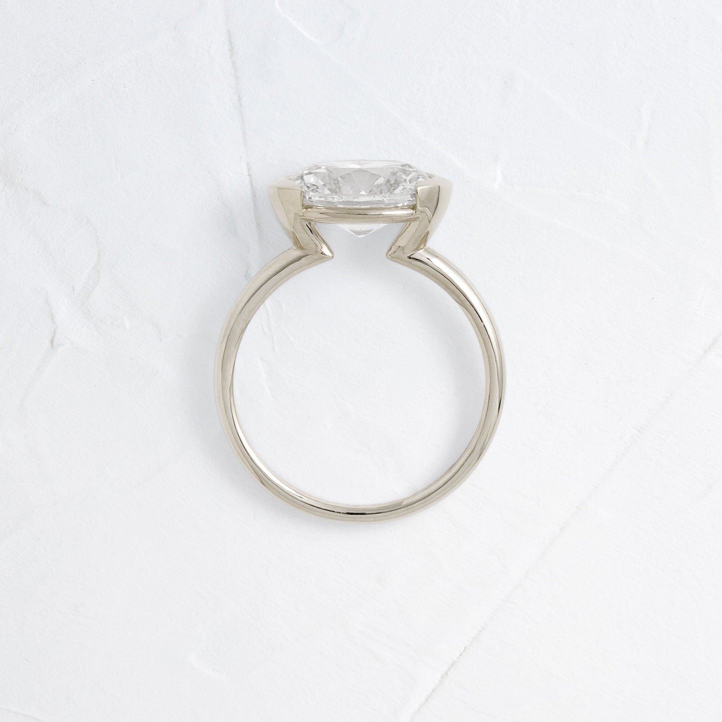 East West Solitaire Half Bezel-Oval Lab Grown Diamond Engagement Ring
