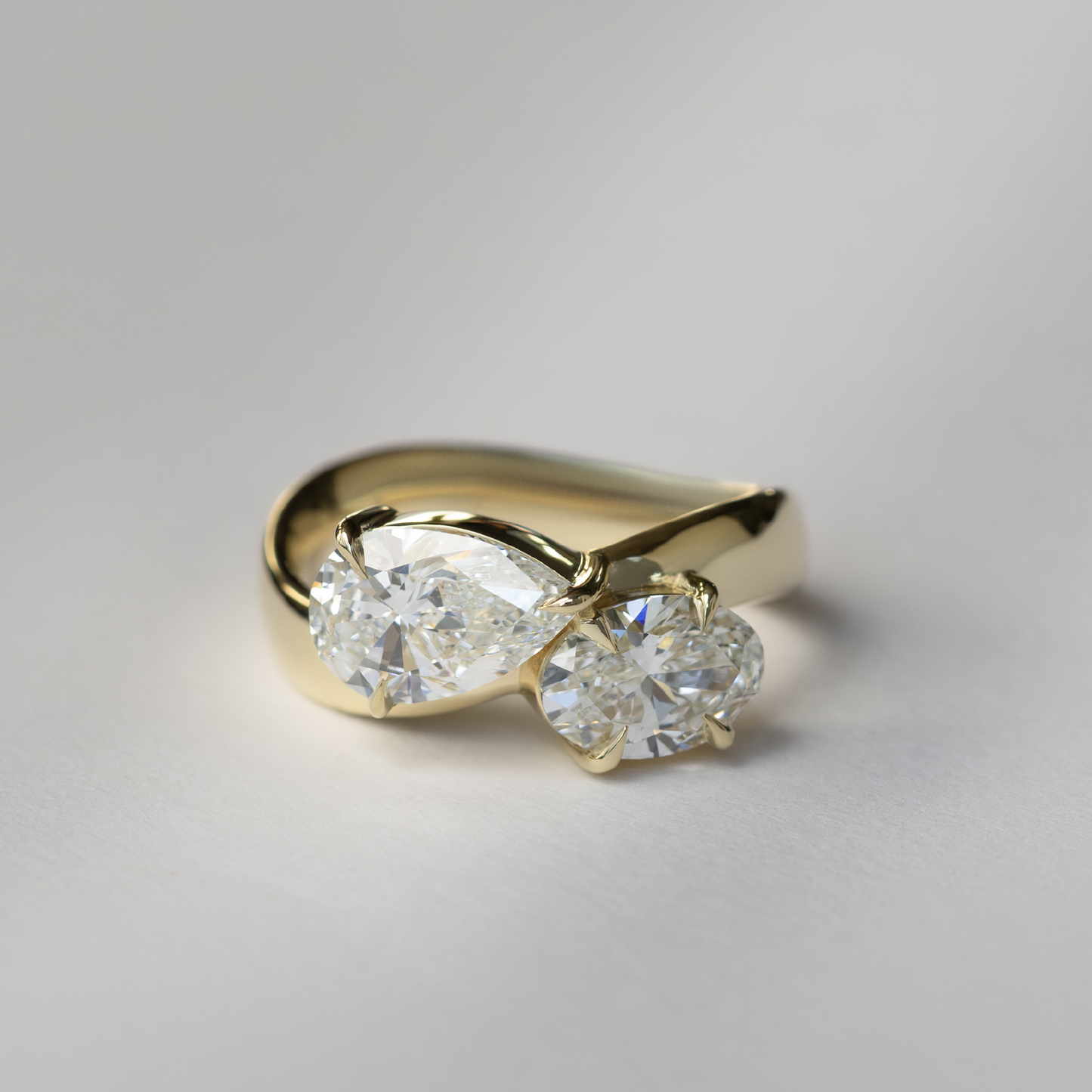 East West Toi Et Moi Curved Band- 1.33 CT Pear & 1.3 CT Oval Moissanite Engagement Ring