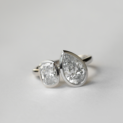 Toi Et Moi Bezel-Pear & Elongated Cushion Lab Grown Diamond Engagement Ring