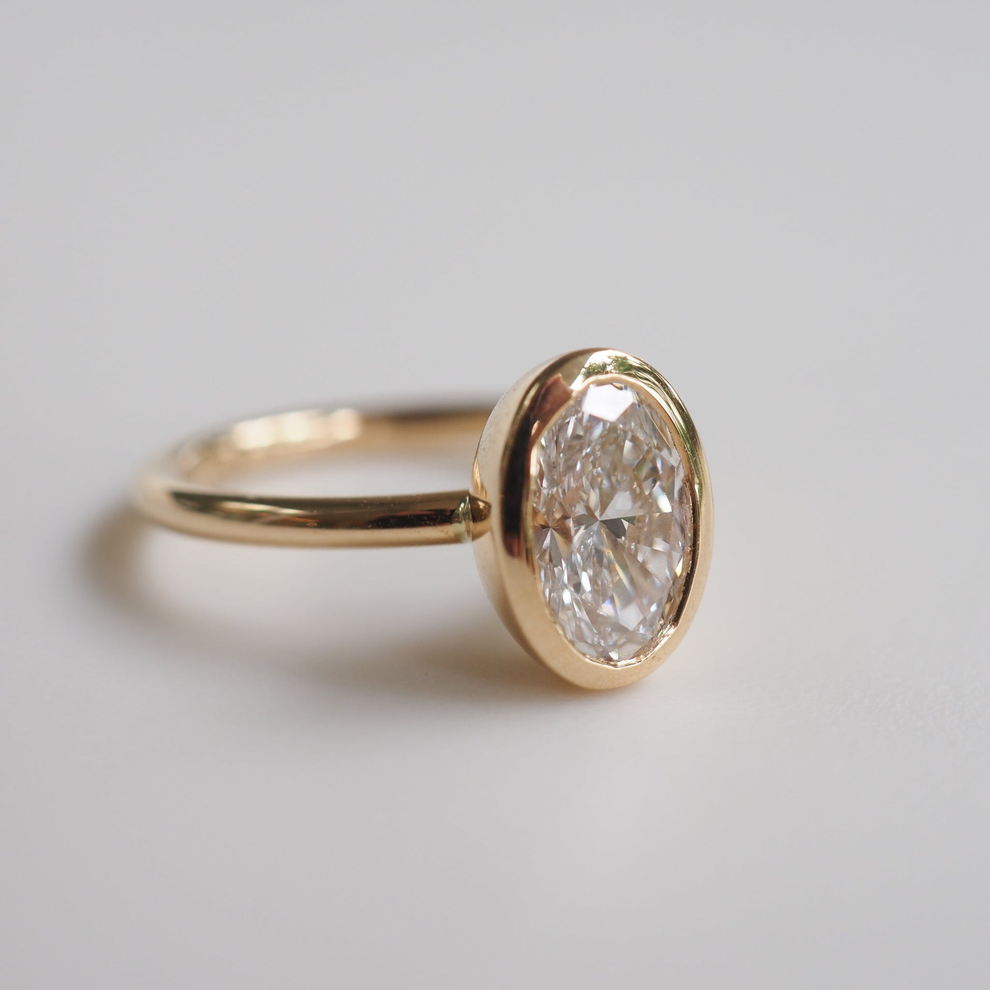 1.50 CT Oval Lab Grown Diamond Bezel Set Engagement Ring in Yellow Gold 1