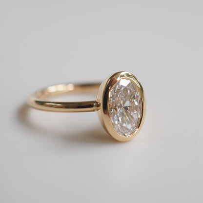 1.50 CT Oval Lab Grown Diamond Bezel Set Engagement Ring in Yellow Gold 1